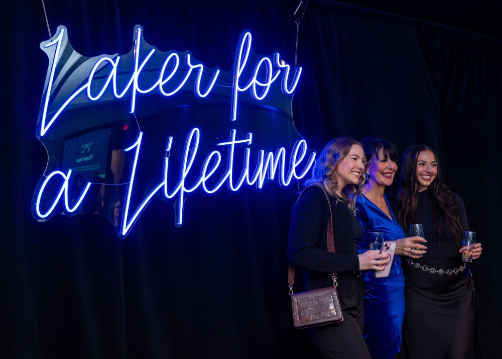 Side view of girls taking picture with President Mantella